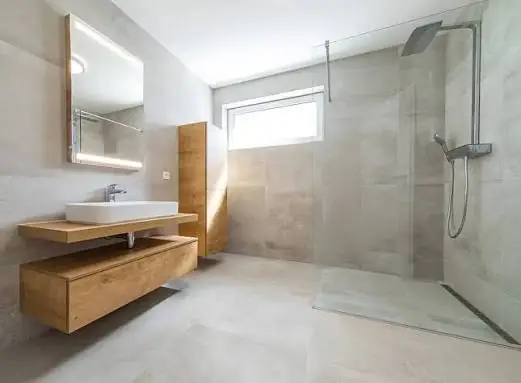 Tiled bathroom with a walk-in shower and timber vanity